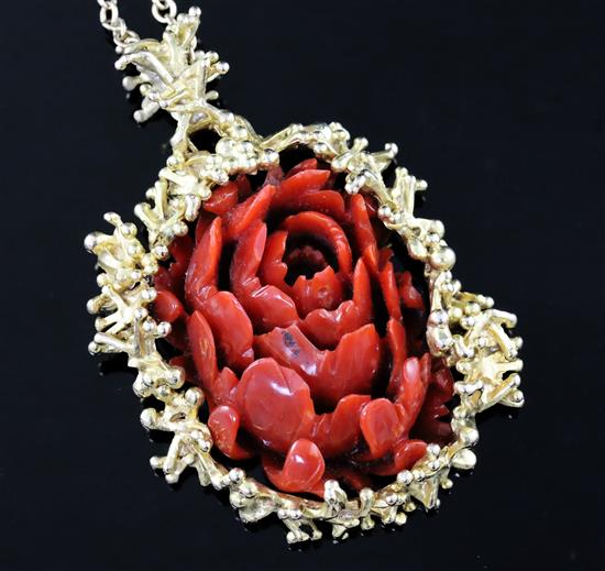 A modernist gold and carved coral oval pendant, with branch-effect mount on gold chain (tests as 9ct)